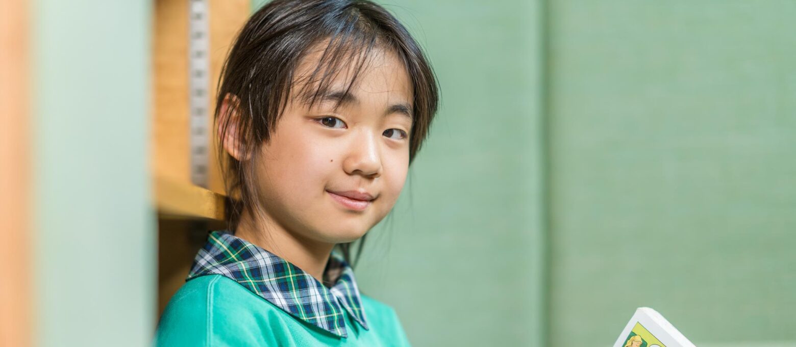 girl holding up a book