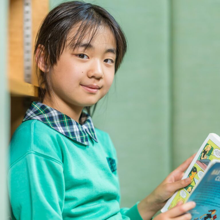 girl holding up a book