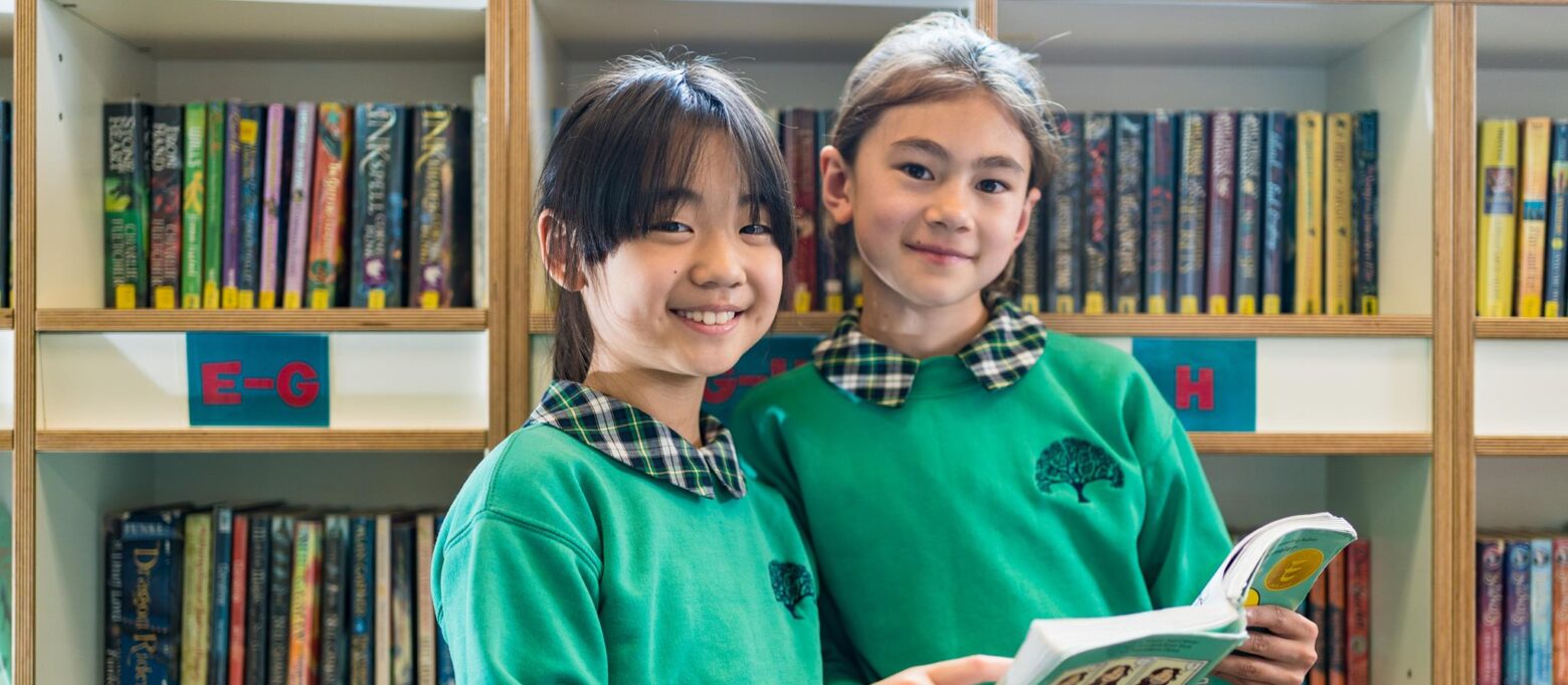 2 girls with a book