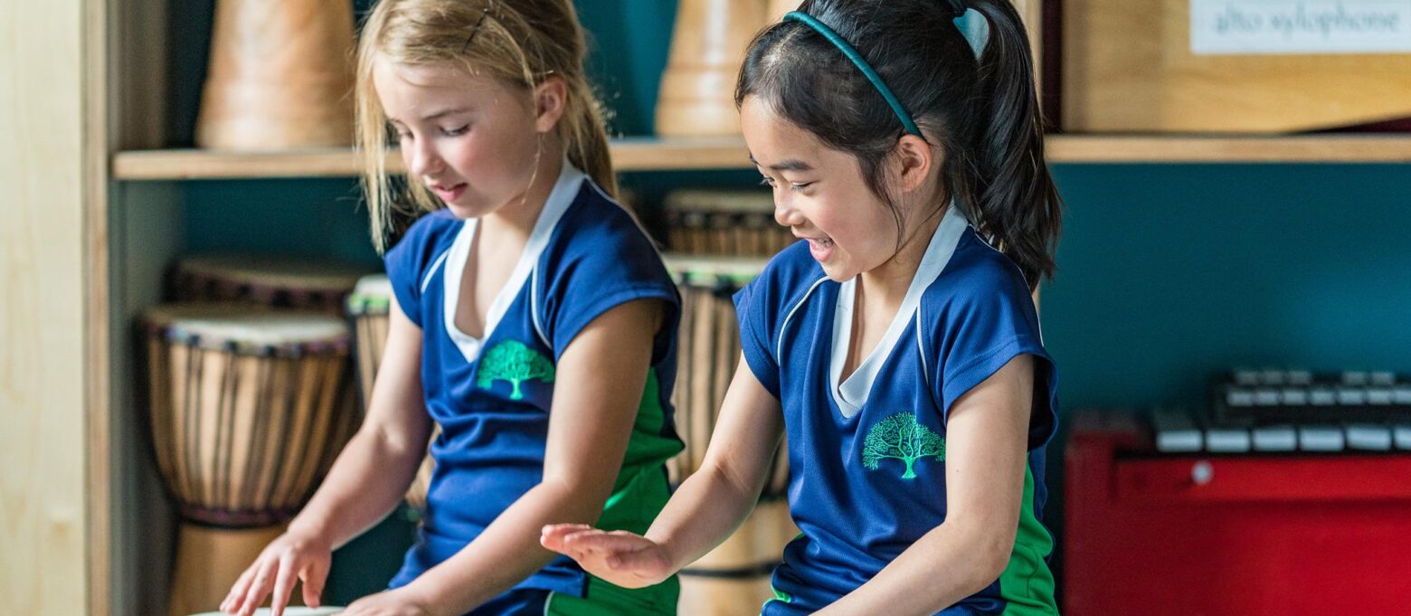 2 girls playing the drums