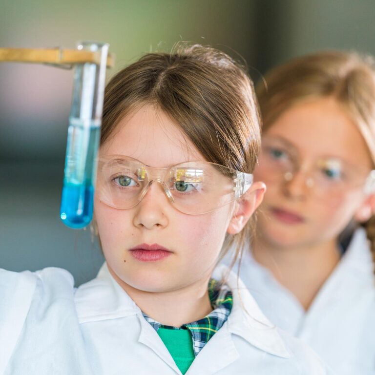 girl looking at a test tube